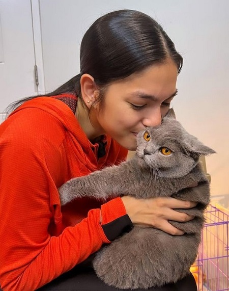 Andrea Torres playing with her cat