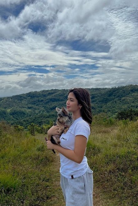 Heaven Peralejo on the hills with her dog