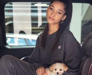 Yasmin carrying a Puppy in hand
